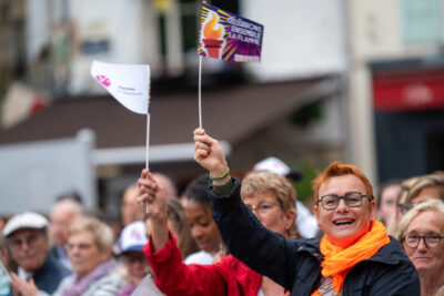 Personne agitant un drapeau lors du passage de la flamme place de la libération à Rambouillet. - Agrandir l'image 2 sur 11, fenêtre modale